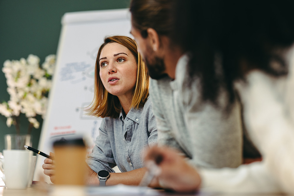 A woman sharing her ideas at a team meeting